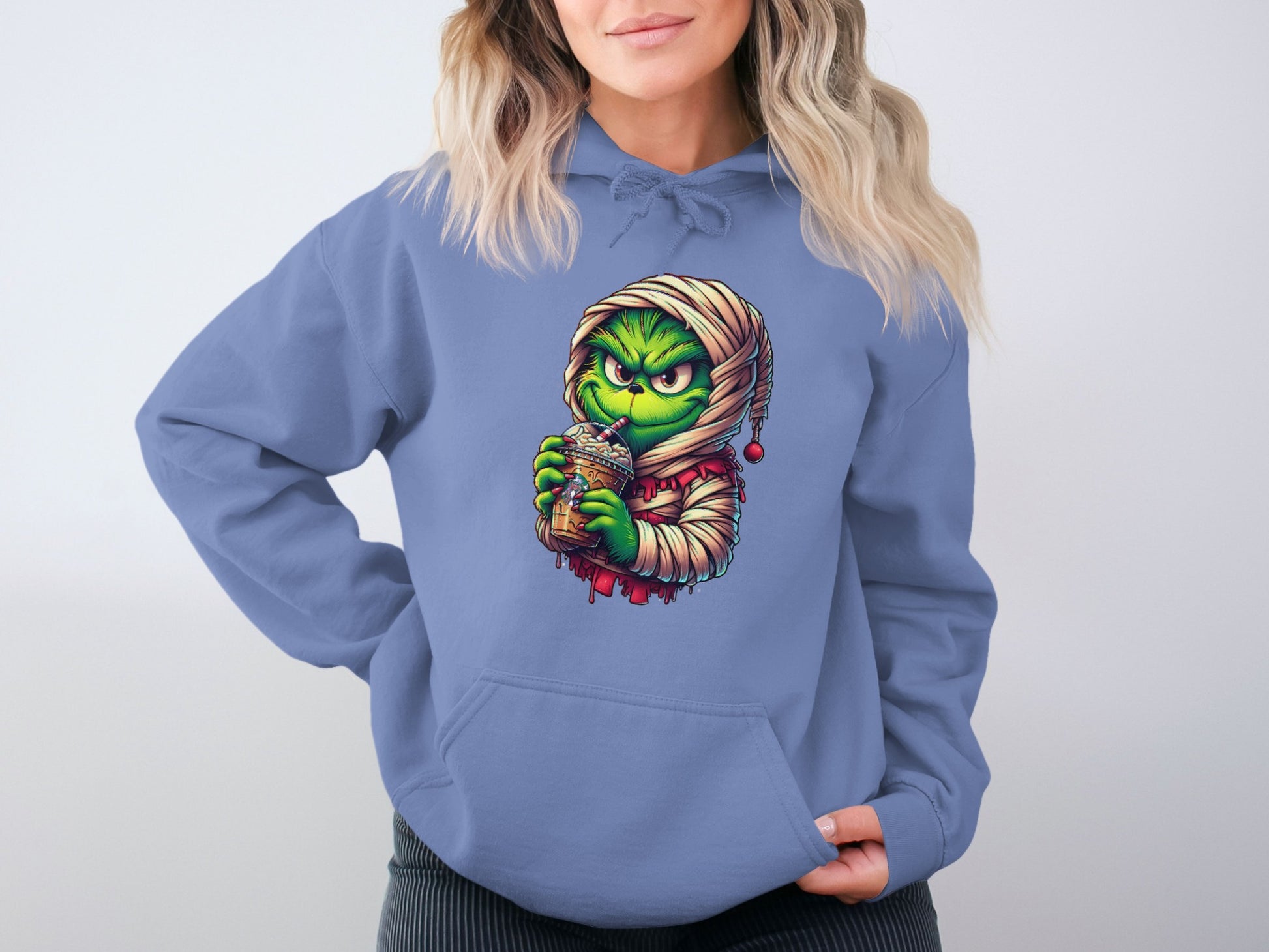 Festive Mischief Green Face Holding Drink Hoodie Product